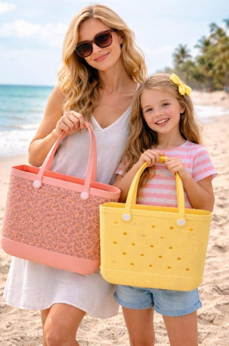 Two women holding colorful C&C bags