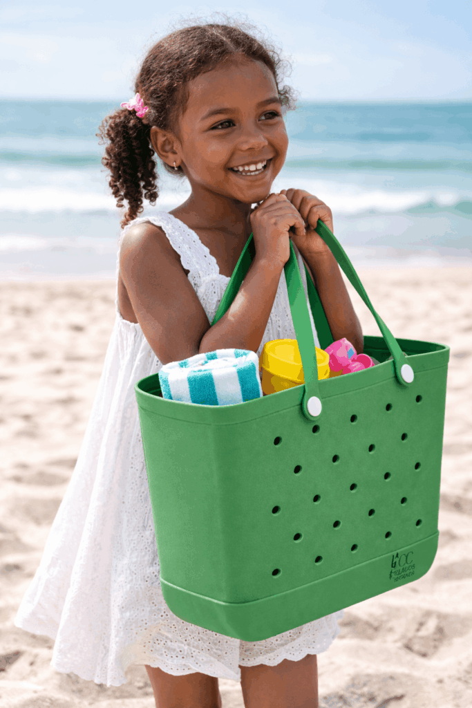 Child holding green C&C bag